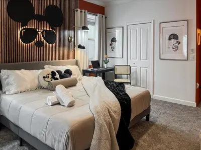 a bedroom with a bed with a panda bear head and sunglasses at Happily Ever Home, Your Family Dream Beyond Disney in Kissimmee