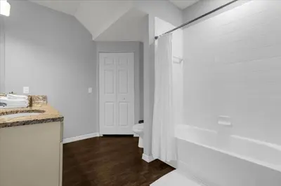 a white bathroom with a toilet and a sink at 3 Bedrooms 2 Bathrooms Lucaya Village 13-107 in Kissimmee