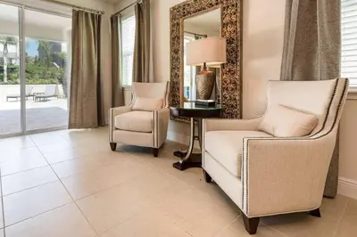 a living room with two chairs and a mirror at 361 Pendant ct in Orlando