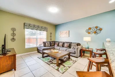 a living room with a couch and a table at Resort Perks and Private Pool Kissimmee Retreat! in Kissimmee
