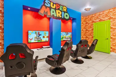 a room with two chairs and a super mario game at New Home 9 Bedrooms and 5 Bath At Storey Lake in Kissimmee