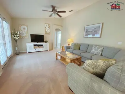 a living room with a couch and a tv at 35 - Relax & Play 4-Bed Villa with Pool & Game Room Minutes to Disney in Orlando