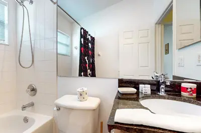 a bathroom with a toilet and a tub and a sink at Disney 15 Min - Sleeps 8 - Private Pool in Kissimmee