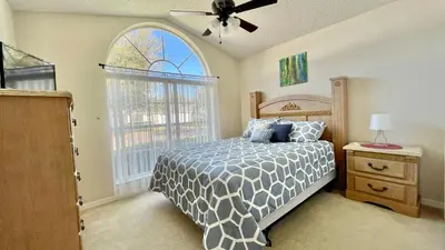 a bedroom with a bed and a large window at The Oasis in Orlando