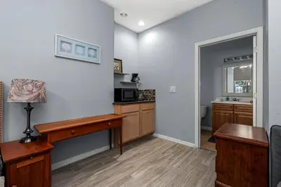 a living room with a kitchen with a table at Near Disney + FREE Clubhouse + Pool + GYM + Sauna in Kissimmee
