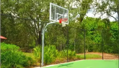a basketball hoop on top of a tennis court at Near Disney + FREE Clubhouse + Pool + GYM + Sauna in Kissimmee