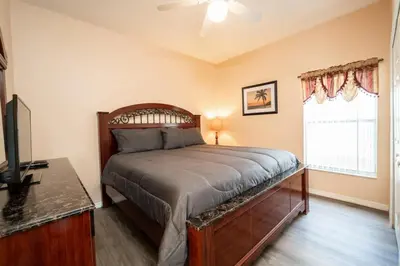 a bedroom with a bed and a television and a window at Sweet Memories in Kissimmee