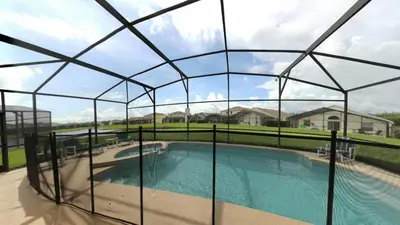 a pool with a glass enclosure around it at Sweet Memories in Kissimmee