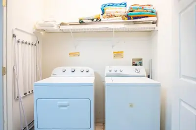two washing machines sitting next to each other in a laundry room at Sweet Memories in Kissimmee