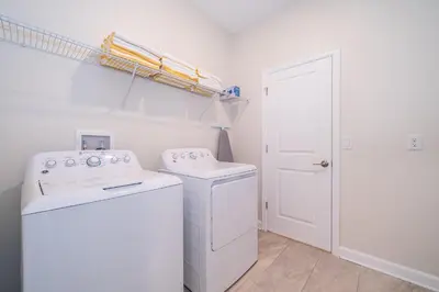 a white laundry room with a washer and dryer at 800MO VILLA 5 BED/5 BA in Orlando