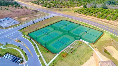 an overhead view of four tennis courts on an island at 800MO VILLA 5 BED/5 BA in Orlando