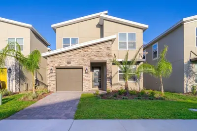 a house with a garage and palm trees at 800MO VILLA 5 BED/5 BA in Orlando