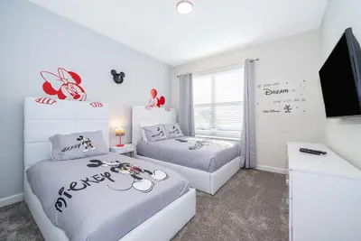 a bedroom with two beds and a flat screen tv at 800MO VILLA 5 BED/5 BA in Orlando