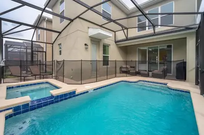 a large swimming pool in a building with a house at 4156DS VILLA 5 BED/5 BA in Kissimmee