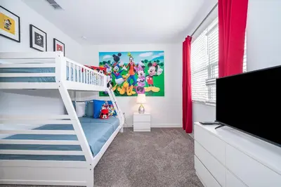 a bedroom with a bunk bed and a tv at 4156DS VILLA 5 BED/5 BA in Kissimmee