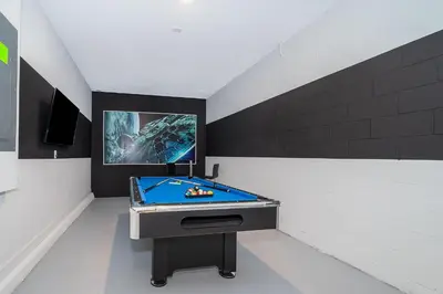 a room with a pool table and a tv at 4176SS STOREY LAKE VILLA WITH PRIVATE POOL in Kissimmee