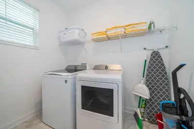 a washer and dryer in a laundry room at 4176SS STOREY LAKE VILLA WITH PRIVATE POOL in Kissimmee