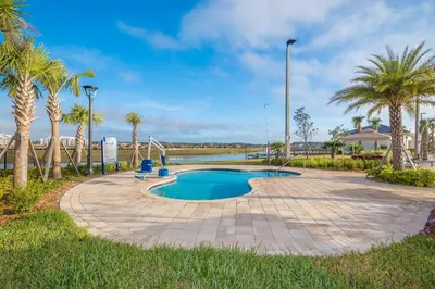 a swimming pool with palm trees in a park at 4176SS STOREY LAKE VILLA WITH PRIVATE POOL in Kissimmee
