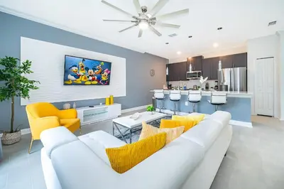 a living room with a white couch and yellow chairs at 2472PB TOWNHOUSE 4 BEDROOMS & 3 BATHROOMS + POOL in Kissimmee
