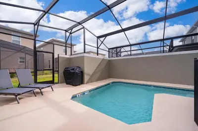 an indoor swimming pool with a glass roof at 2472PB TOWNHOUSE 4 BEDROOMS & 3 BATHROOMS + POOL in Kissimmee