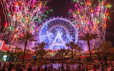 a ferris wheel with fireworks at a carnival at night at Bposhtels Orlando Disney in Kissimmee