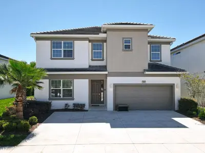 a large white house with a garage at Elegant Villa 12BD-12BA Vacation Haven BV368 in Kissimmee