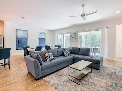 a living room with a couch and a table at Elegant Villa 12BD-12BA Vacation Haven BV368 in Kissimmee