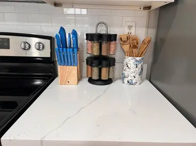 a kitchen counter with wooden utensils and a stove at Quiet home in Metrowest in Orlando