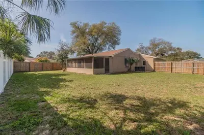 a house in a yard with a fence at Quiet home in Metrowest in Orlando