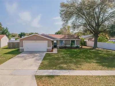 a house with a driveway and a garage at Quiet home in Metrowest in Orlando