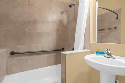 a bathroom with a sink and a toilet and a shower at Sunny Summer Awaits - Renovated Townhome by Disney! in Orlando