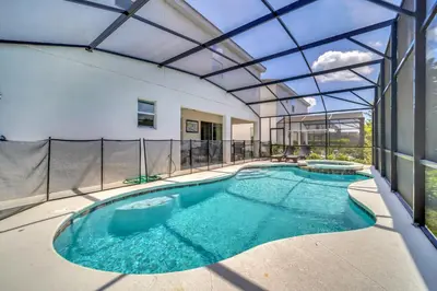 an indoor swimming pool with a glass ceiling at Vacation Paradise Home, Private Pool, Game Room BL102 in Kissimmee