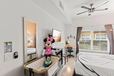 a bedroom with a crib with a teddy bear on it at The Villas at Seven Dwarfs - 4564 Luxury Villa - Near Disney - Water Park in Kissimmee