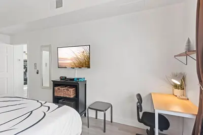 a bedroom with a desk and a bed and a desk and chair at The Villas at Seven Dwarfs - 4564 Luxury Villa - Near Disney - Water Park in Kissimmee