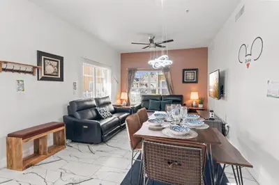 a living room with a table and chairs at The Villas at Seven Dwarfs - 4564 Luxury Villa - Near Disney - Water Park in Kissimmee