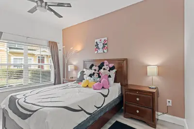 a bedroom with a bed with stuffed animals on it at The Villas at Seven Dwarfs - 4564 Luxury Villa - Near Disney - Water Park in Kissimmee