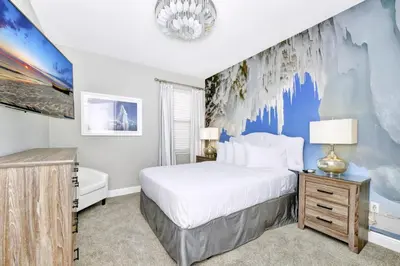 a bedroom with a large bed and a blue wall at Astounding Home Near Disney With Themed & Media Room, Pool Table With Waterpark & Resort Access At Encore Resorts Reunion - 240Cl in Kissimmee