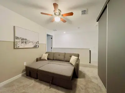 a living room with a couch and a ceiling fan at Modern 3BR3BA Home at The Hub Reserve in Kissimmee