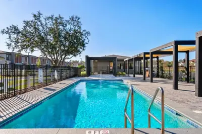 a swimming pool with blue water in a building at Modern 3BR3BA Home at The Hub Reserve in Kissimmee
