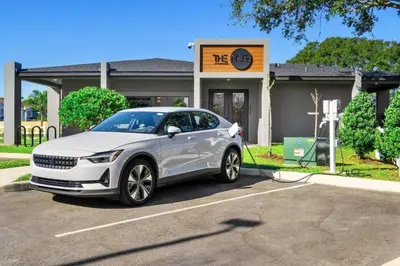 a white car is being charged at a gas station at Modern 3BR3BA Home at The Hub Reserve in Kissimmee