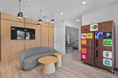 a living room with a couch and a table and a tv at Modern 3BR3BA Home at The Hub Reserve in Kissimmee