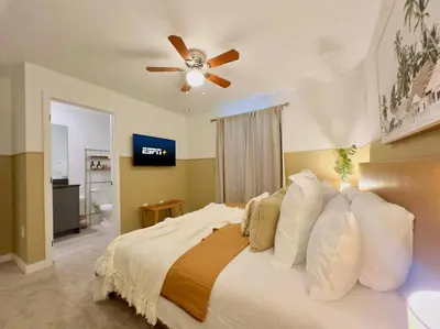 a bedroom with a bed with a ceiling fan at Modern 3BR3BA Home at The Hub Reserve in Kissimmee