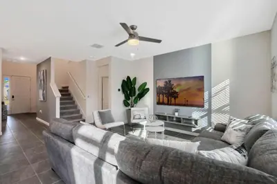 a living room with a couch and a ceiling fan at BV310MB - Disney & Universal heroes - 16 guests in Kissimmee