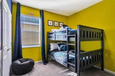 a bedroom with yellow walls and a bunk bed at BV310MB - Disney & Universal heroes - 16 guests in Kissimmee