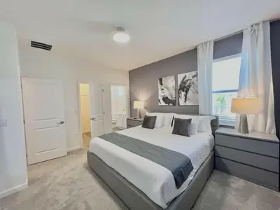 a bedroom with a large bed and a window at BV310MB - Disney & Universal heroes - 16 guests in Kissimmee