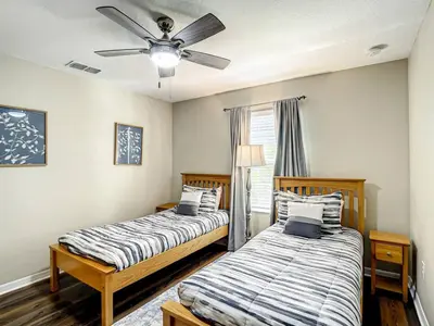 a bedroom with two beds and a ceiling fan at Paradise Palms Resort Townhome Close to Disney in Kissimmee