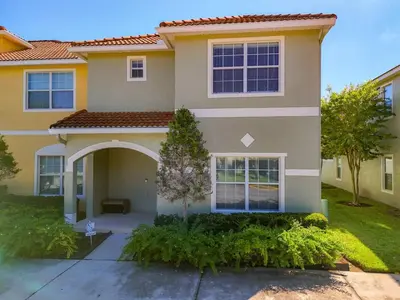 a large house with a driveway in front of it at Paradise Palms Resort Townhome Close to Disney in Kissimmee