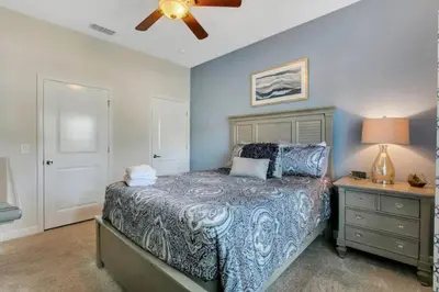 a bedroom with a bed and a ceiling fan at StoreyLake Disney Pool Home, Lake View, By Disney in Kissimmee