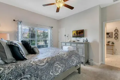 a bedroom with a bed and a ceiling fan at StoreyLake Disney Pool Home, Lake View, By Disney in Kissimmee