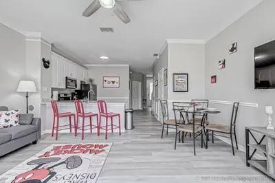 a living room with a couch and a table and chairs at SilverPalm Disney Home, Free Amenities, 3mi Disney in Kissimmee